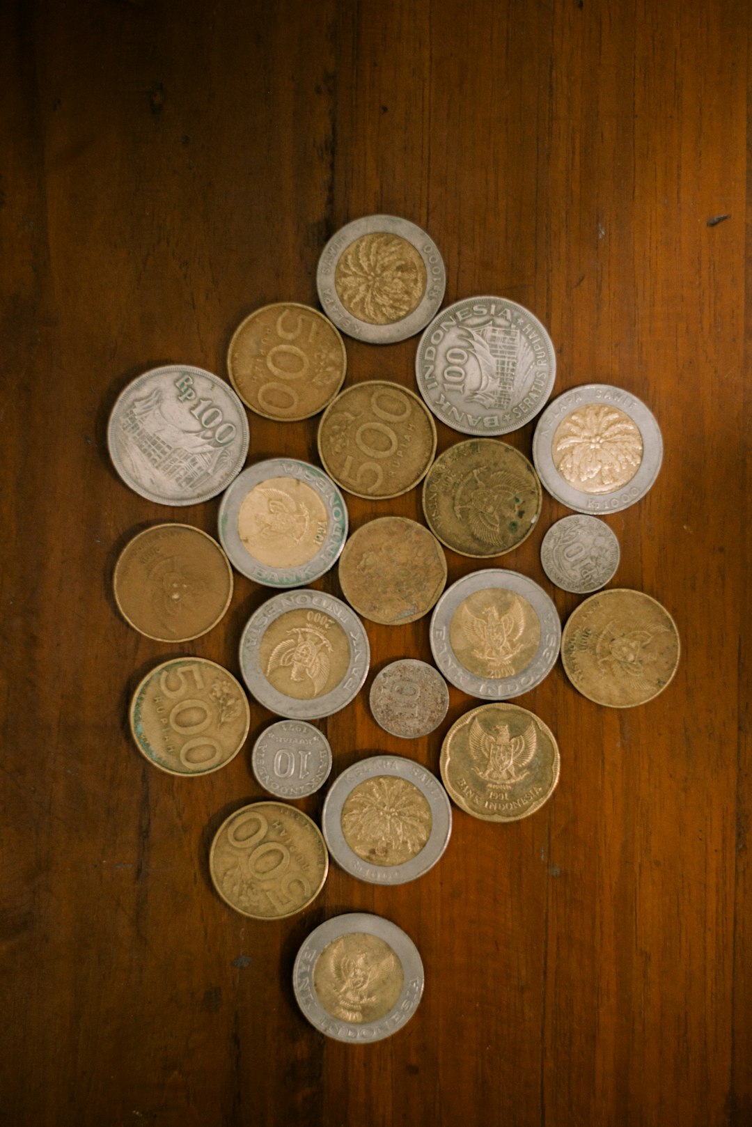 collection-of-various-coins-arranged-on-a-wooden-surface-opk8-tqyrhy